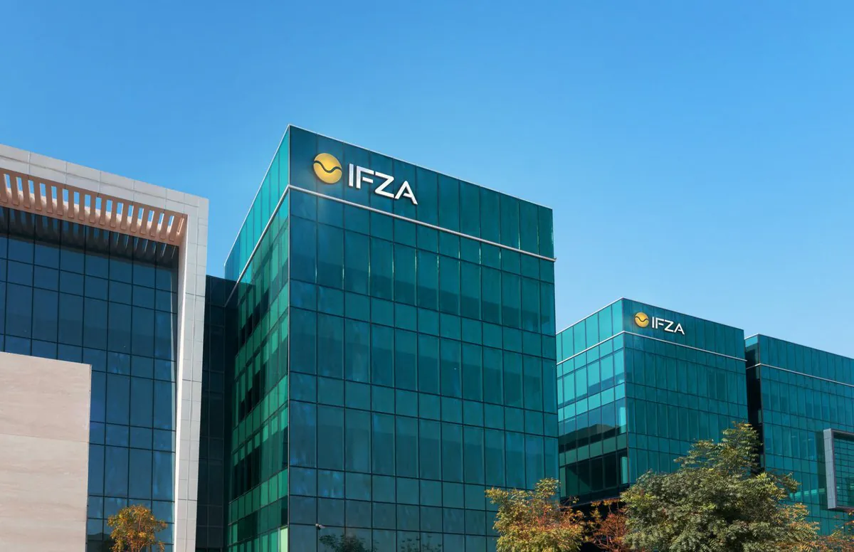 IFZA Business Park headquarters in Dubai Silicon Oasis, green-glass facade under clear sky.
