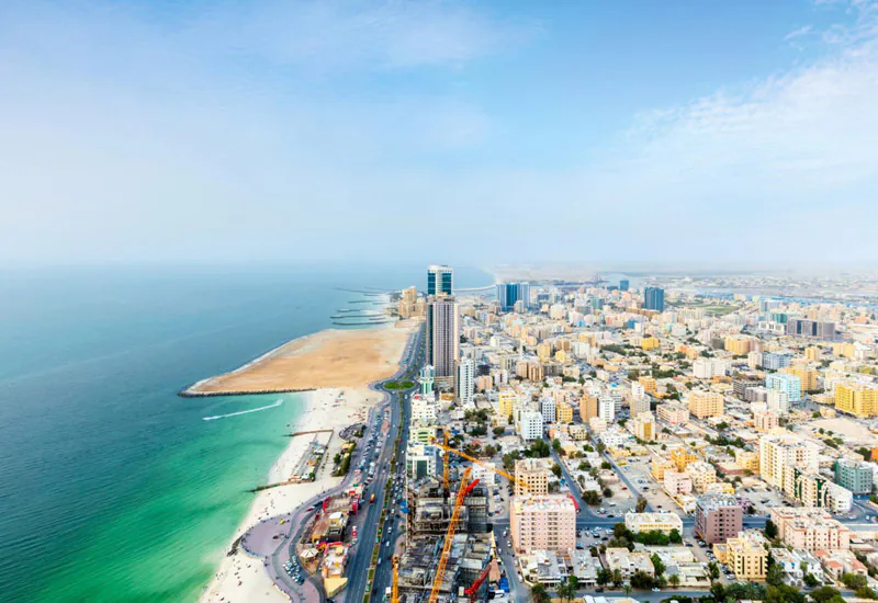 Aerial view of Ajman's coastline, home to Ajman Free Zone beside Ajman Port.